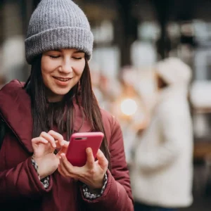 girl-using-phone-outside-street-meeting-with-friends_1303-20032