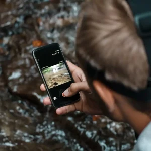 young-handsome-man-taking-close-up-photo-waterfall_176420-4265